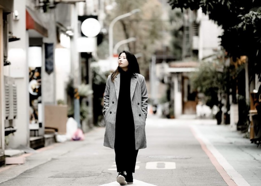 A portrait picture of Lai taken on a small street in Taipei